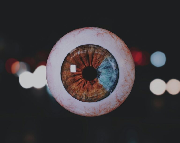 a close up of an eyeball with blurry lights in the background